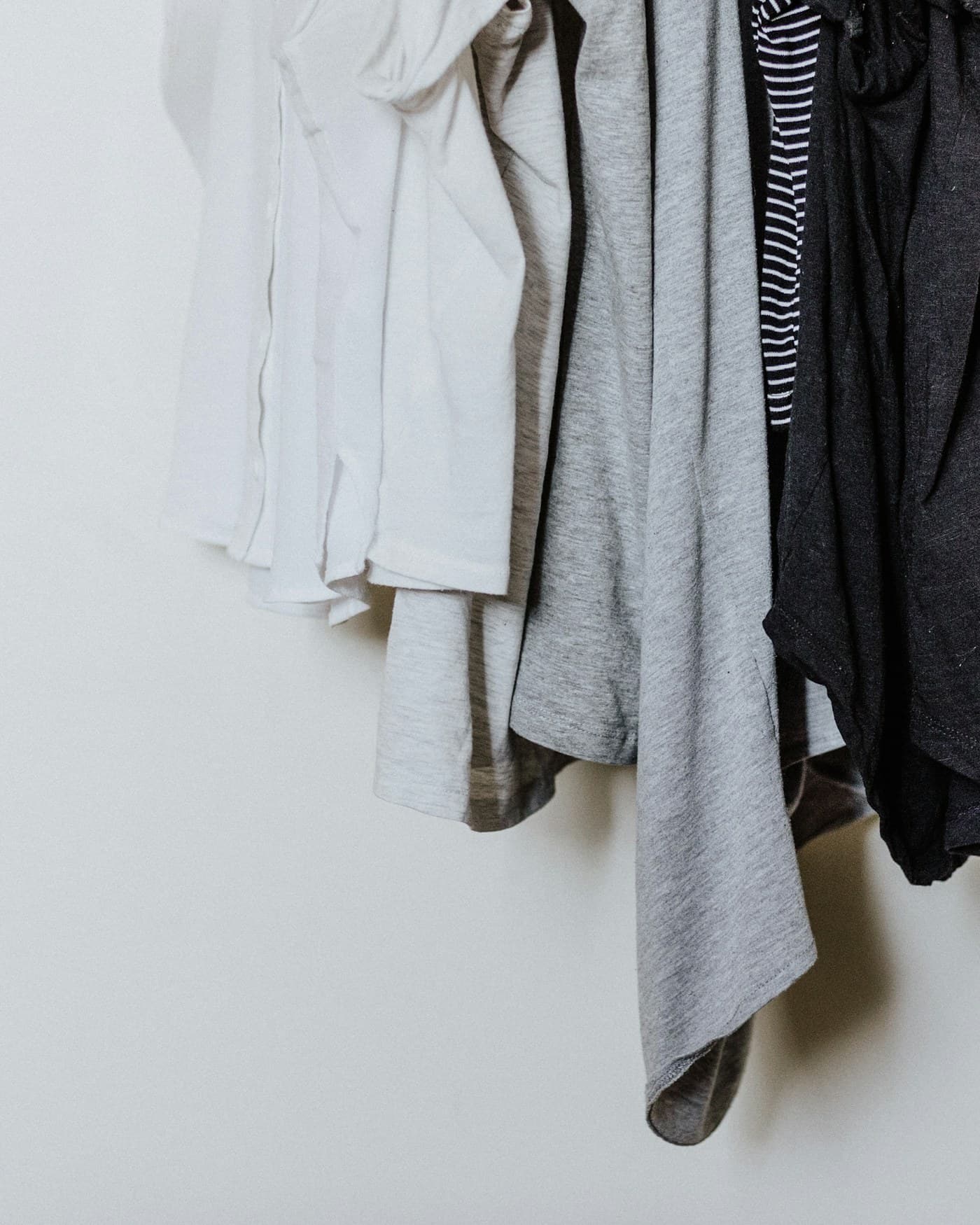 A rail of freshly laundered white shirts
