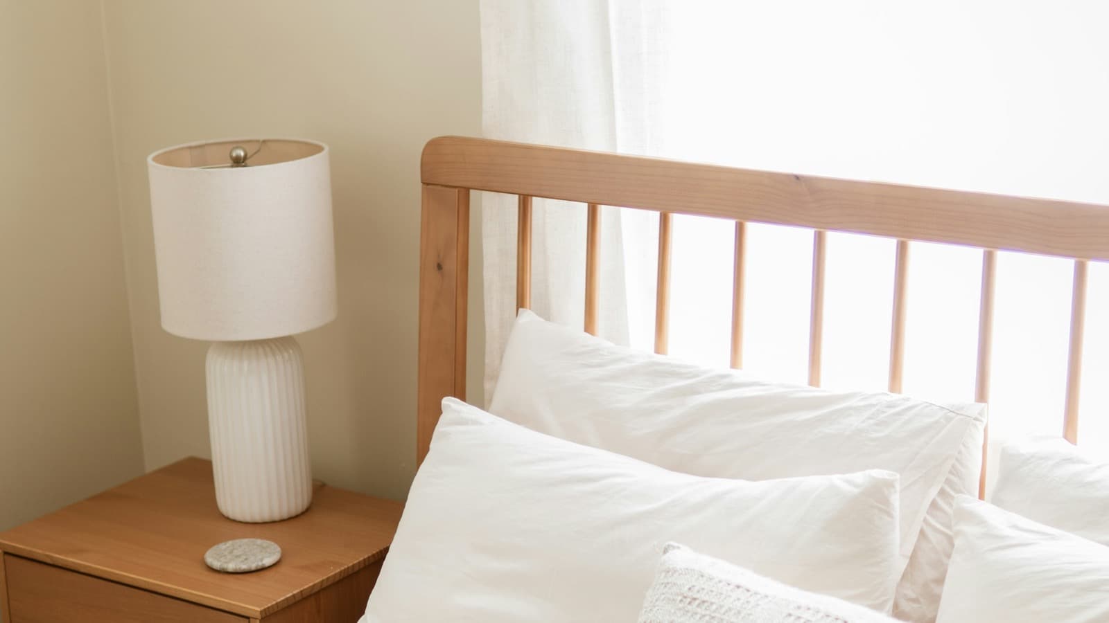 A bright bedroom with crisp white bedding in morning light
